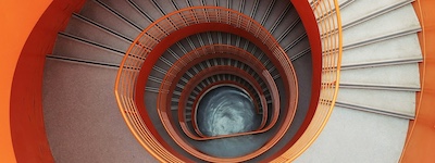 Bird's eye view of an orange spiral staircase